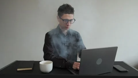 Burnout at work, smoke comes out of the man. Exhausted tired overworked Video stock 308644918