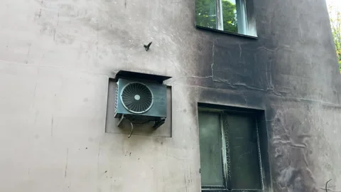 Burnt Apartment Building Facade After Fire | Charred Insulation and Smoke-Damage Stock Footage 342000078