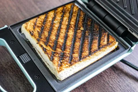 Burnt bread from sandwich maker. Stock Photos