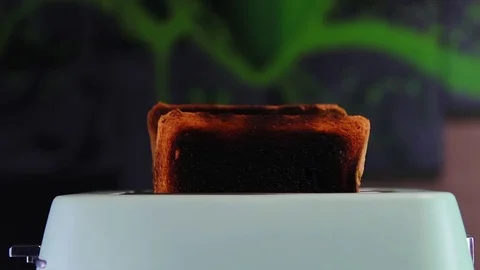 Burnt bread in a toaster. Highly toasted bread in a toaster. Stock Footage 124514276