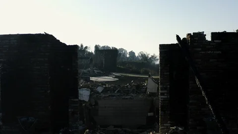 Burnt bricks of damaged buildings scattered after the Woolsey Fire - 2018 Stock Footage 98944556