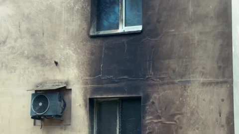 Burnt Building Facade After Fire with Damaged Insulation and Melted Windows Stock Footage 337272861