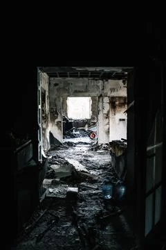 Burnt corridor and interior with charred walls and debris after a fire. Home Stock Photos