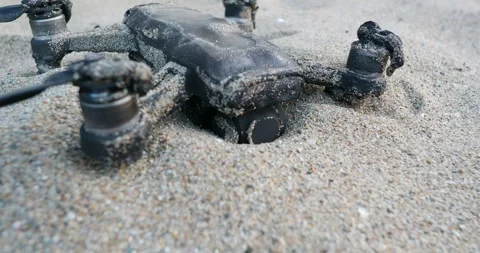 Burnt damaged drone quadcopter on sand. 動画素材 277609632