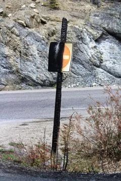 A burnt Do Not Enter Sign with a road in the background Stock Photos