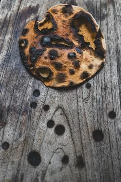 Burnt flatbread on a weathered wooden table Stock Photos