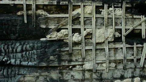 Burnt log wall with remnants of plaster Stock Footage 138419629