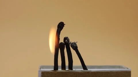 Burnt matchsticks on yellow background Stock Footage 169943084