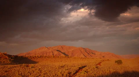 BURNT ORANGE MOUNTAIN DRAMATICALLY LIT UHD 4K Stock Footage 45344626