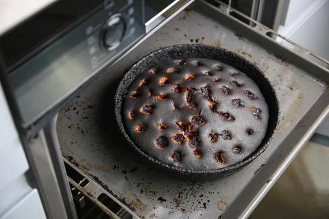 Burnt pie in the oven. Stock Photos