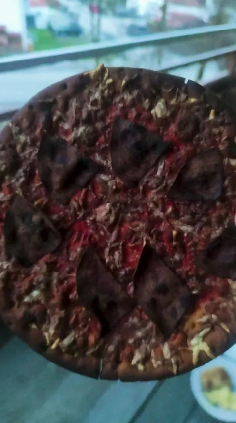 Burnt pizza close-up in the chef's hand Stock Footage 263908100