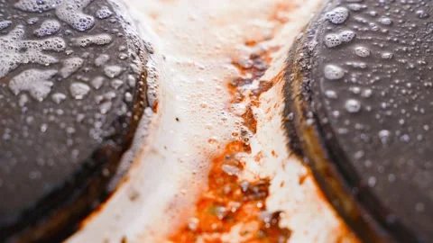 Burnt pollution of electric stove is sprayed with foam detergent close-up Stock Footage 200776465