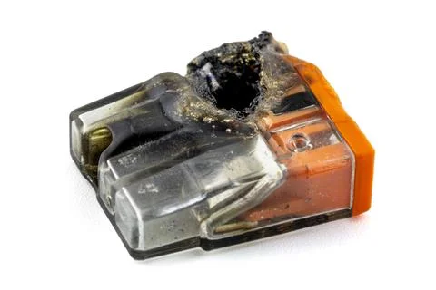 Burnt quick coupler for electric cables with three inputs, isolated on white  Stock Photos