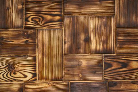 Burnt rectangular wood shapes tiled into geometric wood background. parquet. Stock Photos