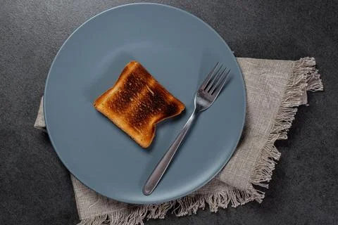 Burnt slice of bread due to failure cooking in bread toaster, Stock Photos