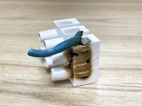 A burnt terminal block with a damaged electrical wire Fotos de archivo