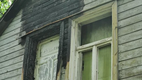 Burnt Window Frames and Charred Wooden Facade of Abandoned House – Rural USA Stock Footage 310538301