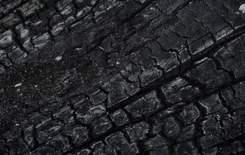 Burnt wood texture close up, background, selective focus, slight blur Stock Photos