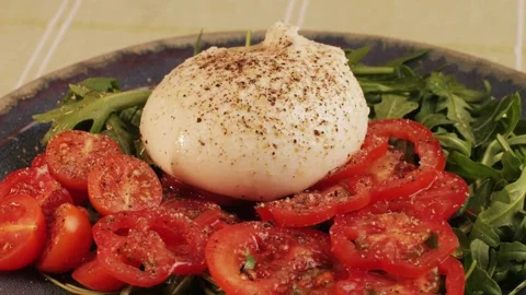 Burrata or Mozzarella cheese on fresh tomatoes and green arugula on plate close Stock Footage 270545733