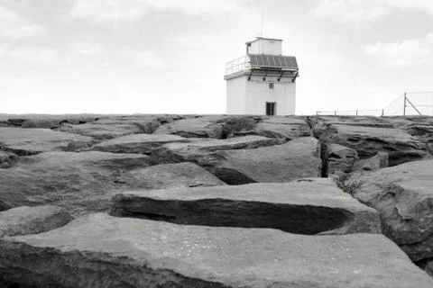 Burren lighthouse on rocks Stock Photos
