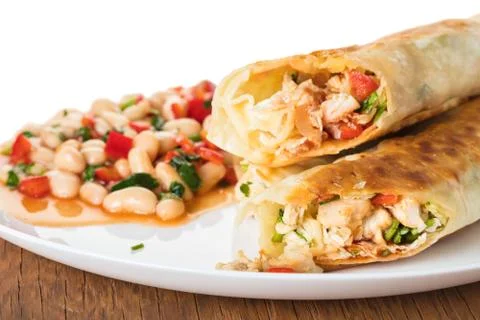 Burrito with garnish of beans Stock Photos