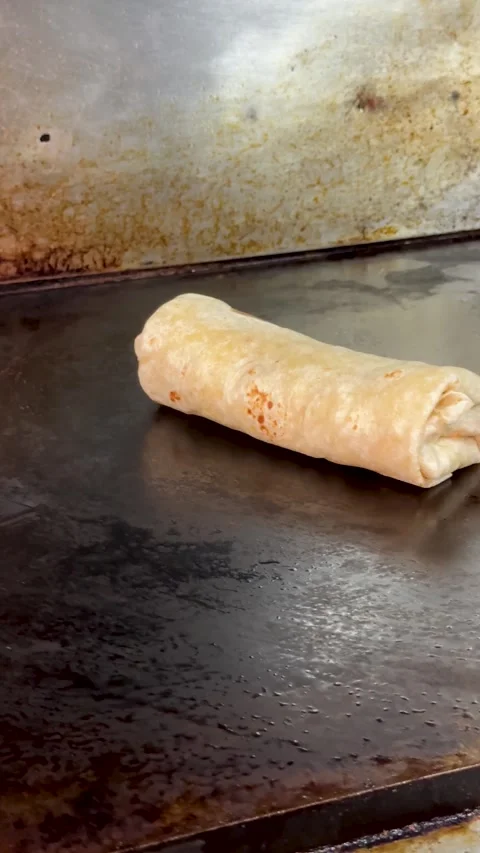Burrito Grilling on Hot Griddle Stock Footage 318749292