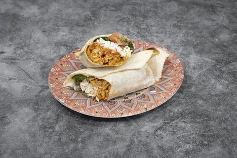 A burrito is on a plate Stock Photos
