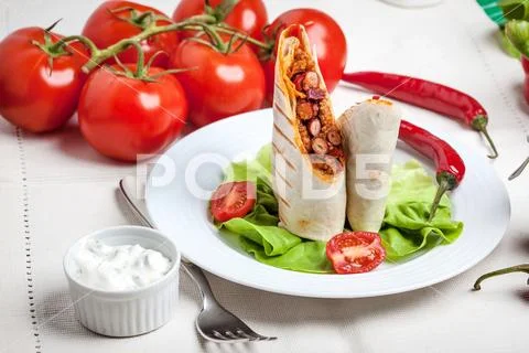 Burritos filled wiht minced meat, bean and vegetables. Stock Photos