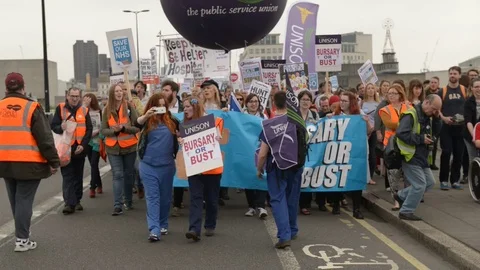 Bursary or Bust protest march by NHS medical students &amp; junior doctors/nurses. Stock Footage 71170693
