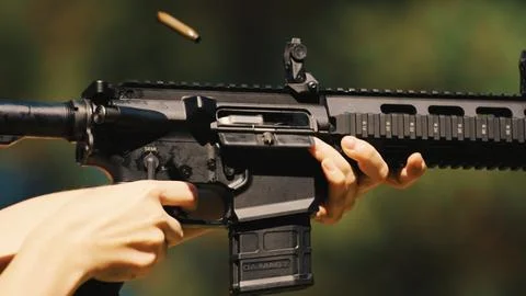 Burst fire from an automatic rifle. Continuous firing of bullets. Used in combat Stock Photos