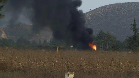 Burst Oil pipeline in Mexico burning panning onto wind Turbine 4K Stock Footage