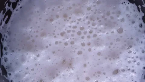 Bursting bubbles of thick white beer foam. View from above Видео 158153048