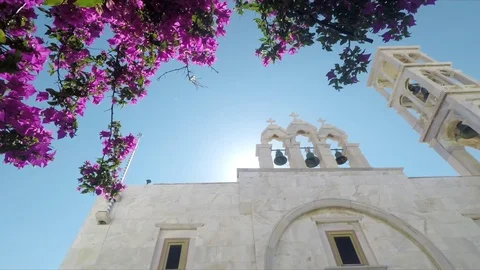 Bursting sunlight through bell tower of orthodox church in Santorini, Greece. Stock Footage 116455217
