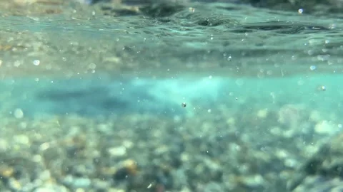 Bursts of bubbles travel rapidly as waves disrupt the calm, producing trails Stock Footage 314119866