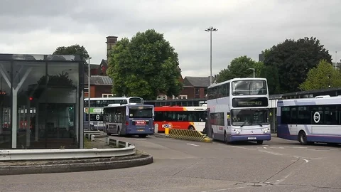 Bury bus station with double decker bus and passengers crossing the busway Stock Footage 72401926