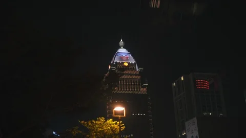Bus blocking the view of Shing Kong Life Tower in Taipei, Taiwan at night Stock Footage 129554464