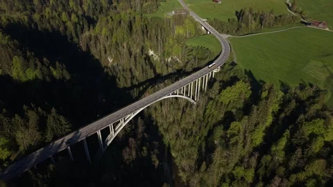 Bus crossing large bridge over valley aerial side view 動画素材 333948945