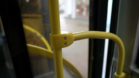 The bus doors close and the bus pulls away from the stop. Close-up of handrail 스톡 동영상 124844722