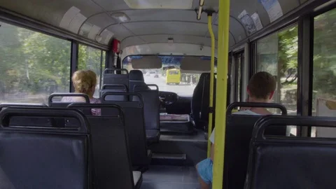 Bus driver is driving the bus. And couple passengers are sitting. Stock Footage 78758875