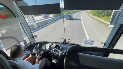Bus Driver Navigates Highway From Front Seat, Lisbon Express Sign Visible Stock-Footage 318361256
