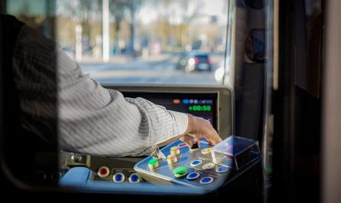 Bus Driver Opening Doors with Control Panel in Urban Traffic 스톡 사진