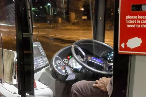 Bus driver sitting in bus cab Stock Photos
