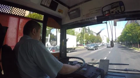 Bus Driver Sitting at Steering Wheel and Driving on City Road 库存影片 67561103
