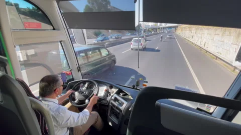 Bus Driver At Wheel On Open Highway Inside City Bus Cockpit Stock Footage 318355516