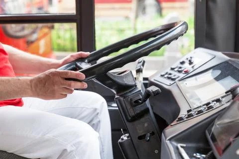 Bus driver at work, holding steering wheel Stock Photos