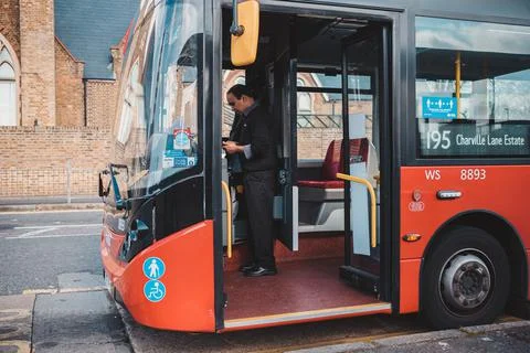 Bus Drivers changing at the bus stop in the middle of the day Stock Photos