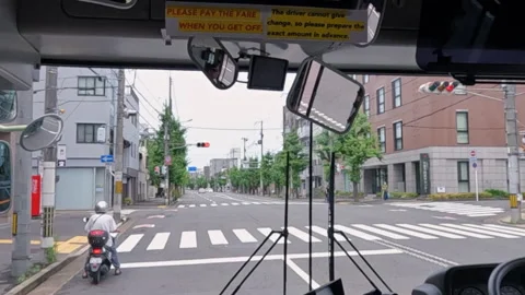 Bus Driver’s View Approaching Urban Intersection on Quiet Street in Kyoto, Japan Stock Footage 341568050