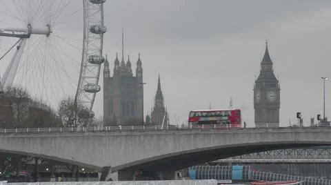 Bus drives over Waterloo Bridge with Big wheel &amp; Westminster behind Stock Footage 45532273