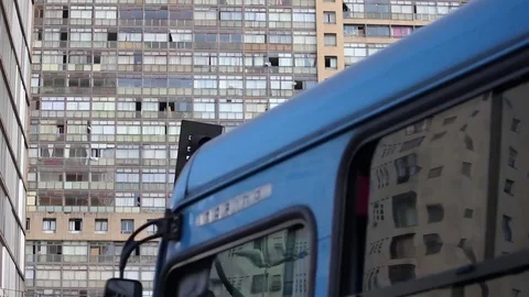 Bus driving by with a building background Stock Footage 71500904