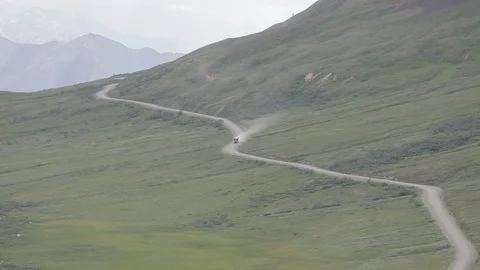 Bus Driving Down Hillside Road in Denali National Park in Alaska Stock-Footage 121478411